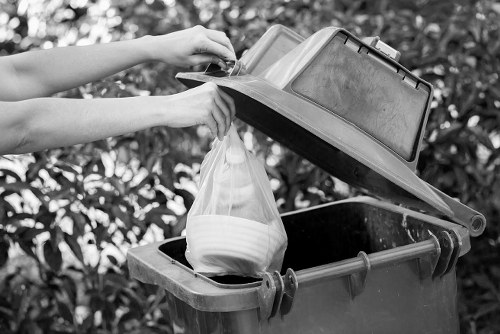 Homeowner loading waste into a skip container in Blackheath